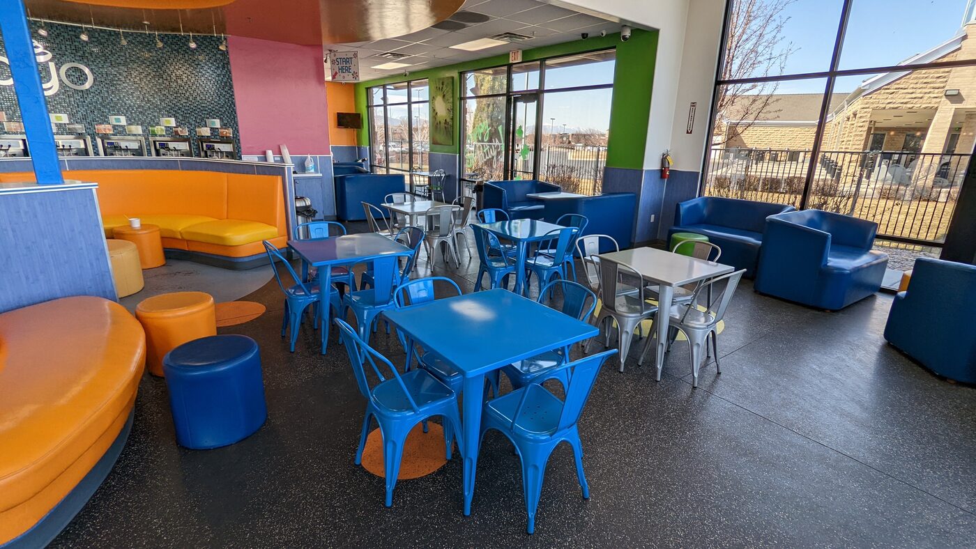 American Fork dining area with bright blue chairs and orange booths