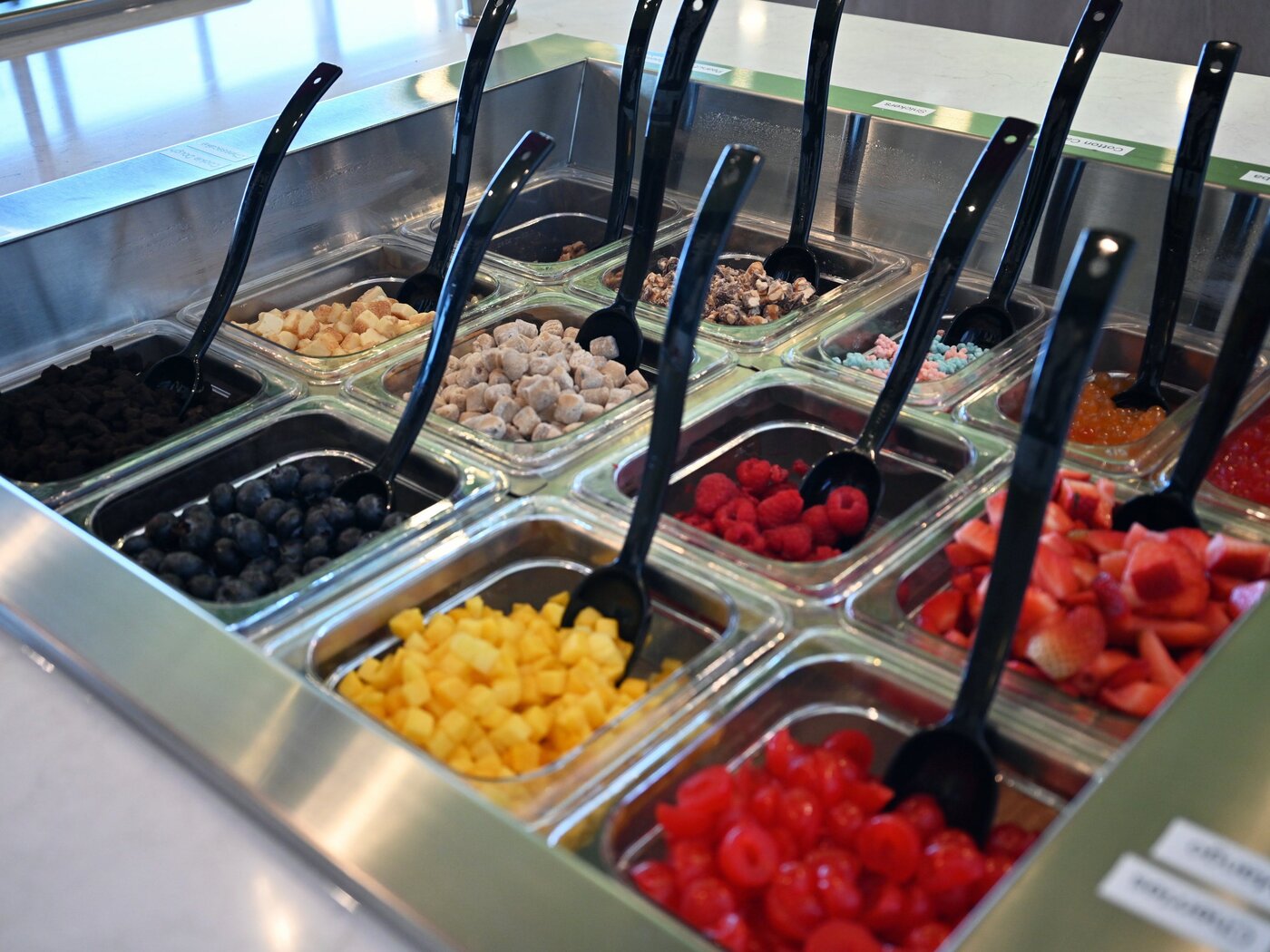 Spanish Fork topping bar close-up with strawberries, raspberries, mango, blueberries and mochi