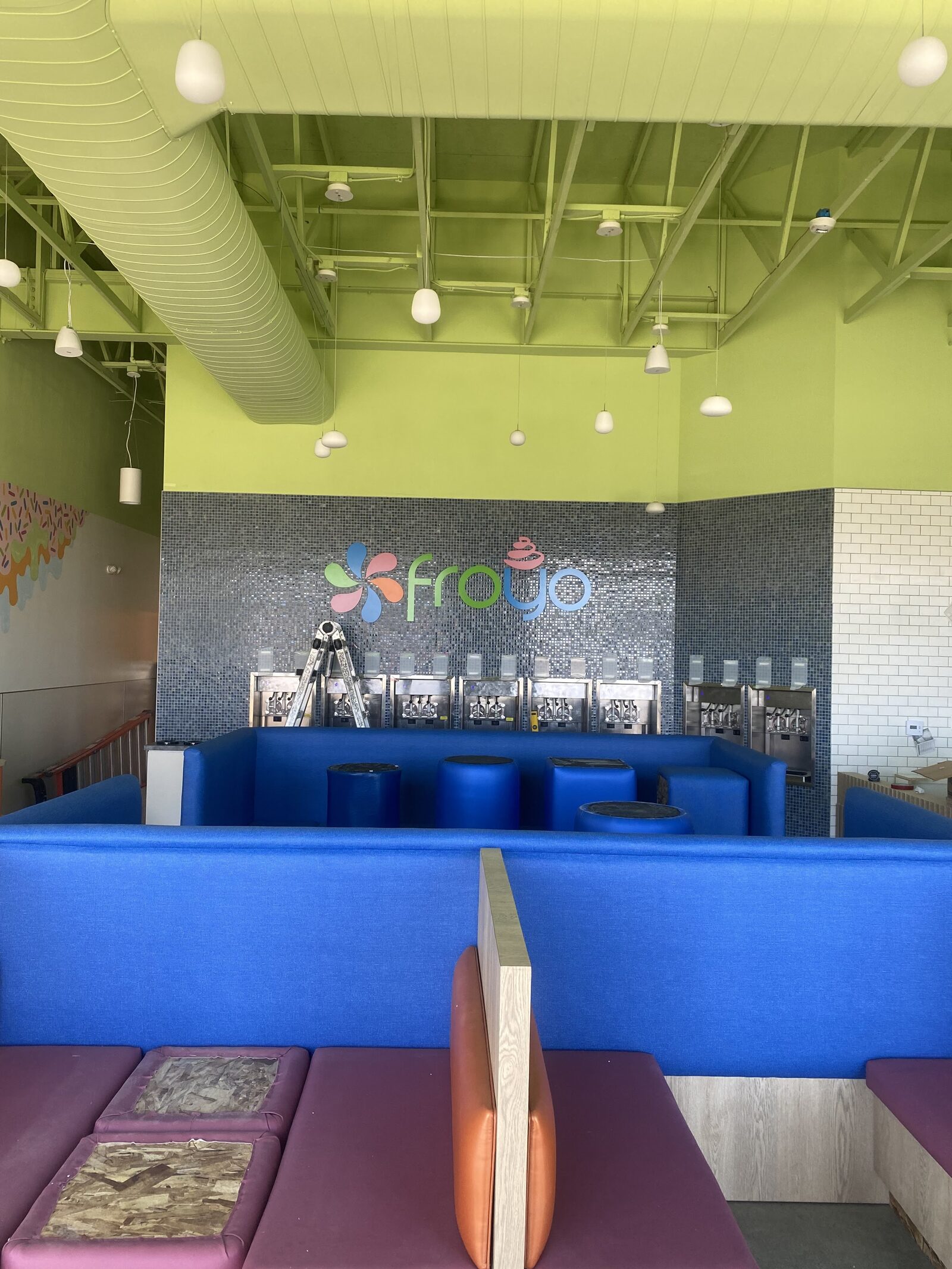 Saratoga Springs interior with blue booths and froyo machine wall