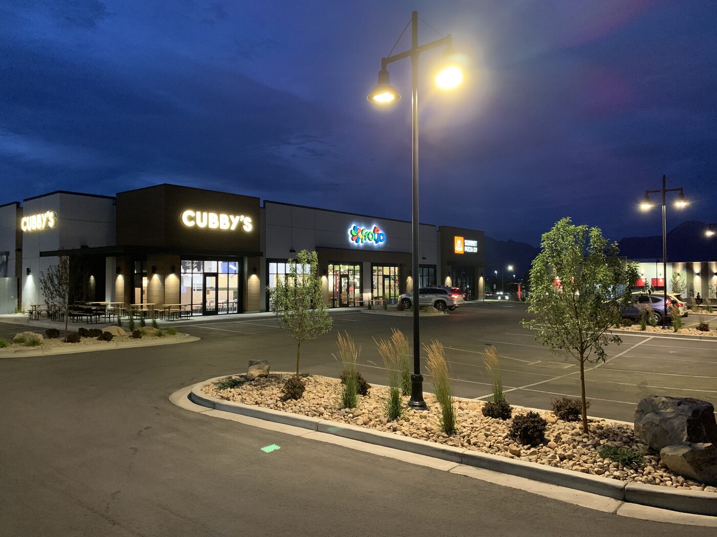 Saratoga Springs Froyo storefront at night next to Cubby's
